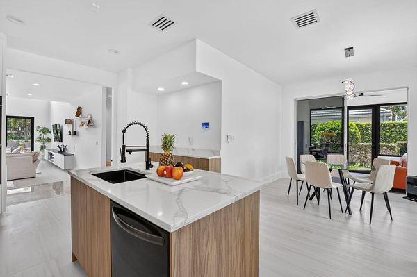 Kitchen island sink looking toward the breakfast area and patio doors