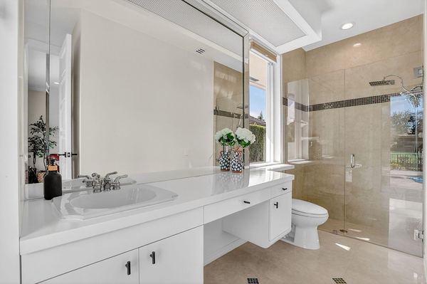 Bathroom with a white vanity and a glass-enclosed shower