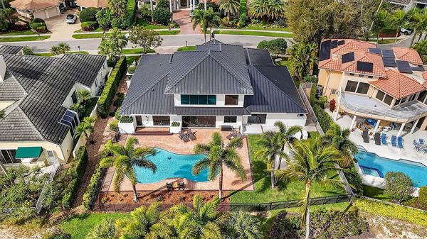 Close aerial view of the home, pool and surrounding landscaping